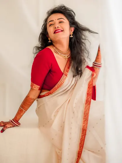 A joyful bridal portrait taken in our studio. The simple white background and the bride's radiant smile make for a clean and happy image.
