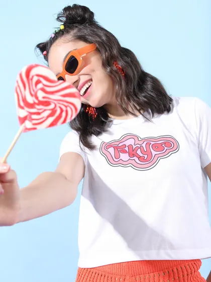 A sweet and playful look styled for Tokyo Talkies, with a simple graphic tee and a heart-shaped lollipop as a fun prop.