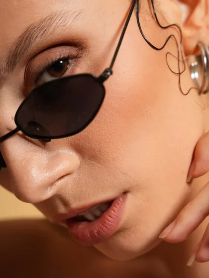 A great beauty headshot is all about the details. This close-up focuses on flawless skin, subtle expression, and the clean lines of the accessories, delivering a polished and professional look perfect for beauty campaigns or model portfolios.