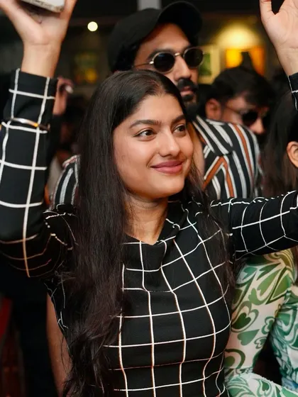 Hands up and ready to party. The energy is contagious.