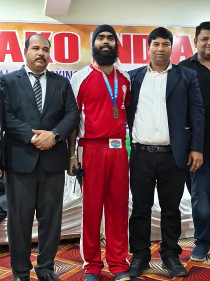 Our team at the National Kickboxing Championships 2024 in Jaipur, Rajasthan. Posing with officials and our medal-winning athlete.