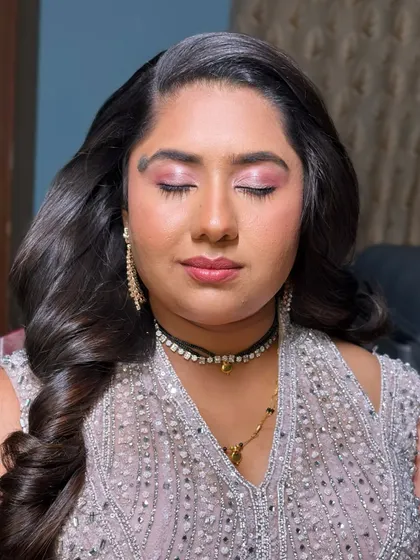 A reception look that is all about sparkle and charm. I used shimmering pink eyeshadow and a matching lip to create a look that is both glamorous and fun.