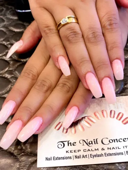 A classic and elegant set of long, coffin-shaped nails in a soft, milky pink color. This is a timeless choice for a clean and polished look.