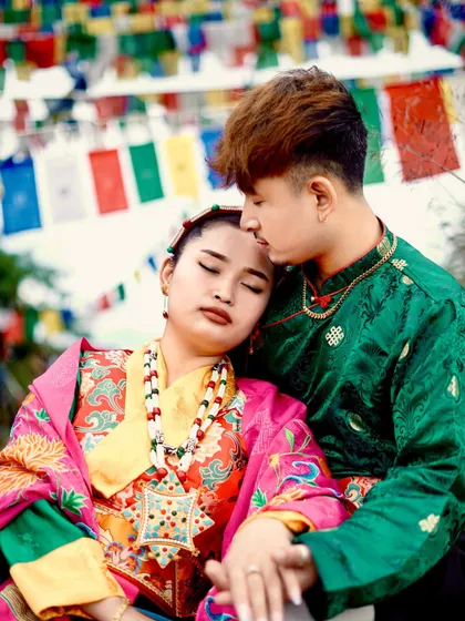 A tender moment captured during a cultural pre-wedding shoot. The groom gently holds the bride, highlighting the beautiful details of her traditional jewelry and attire.