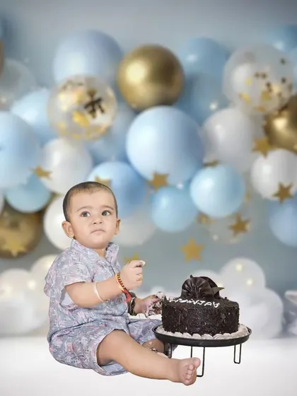 A classic cake smash session is a fun and messy way to celebrate a first birthday. I provide a simple, clean setup with balloons to keep the focus on your little one's joyful expressions.