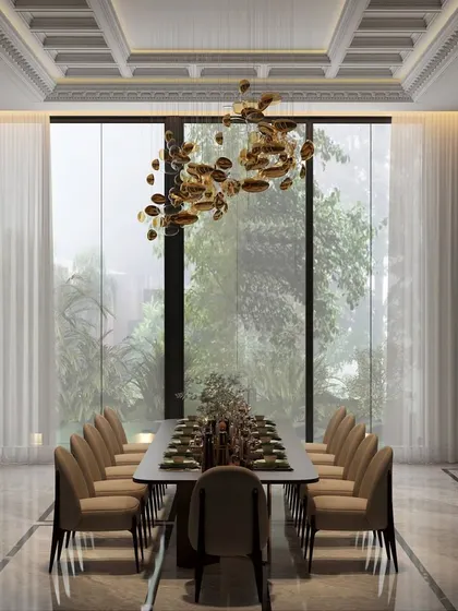 A symphony of light, texture, and drama defines this dining space. A cascading chandelier illuminates the sleek marble table, creating an ethereal glow that makes every meal feel like a special occasion.