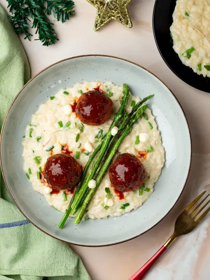 Creamy risotto with meatballs and fresh asparagus. We used soft lighting and careful plating to give this dish an elegant and sophisticated look, suitable for a high-end restaurant.