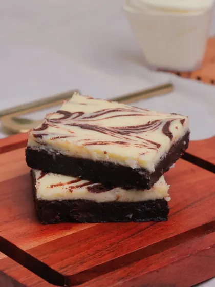 The best of both worlds. Our Cheesecake Brownie features a layer of creamy, tangy cheesecake swirled into our signature dark chocolate brownie base for a truly indulgent experience.