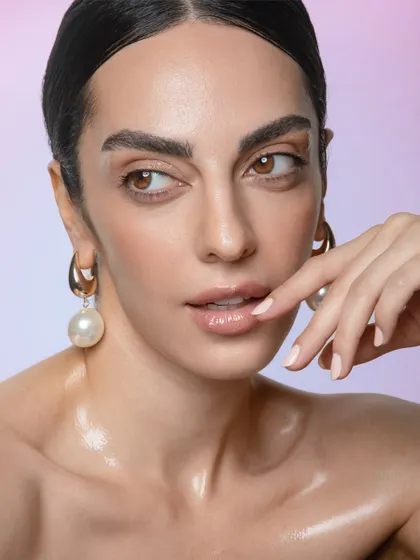 A soft and thoughtful pose. The natural makeup look allows the model's features and expression to take center stage.