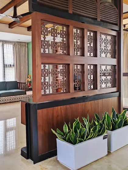 Snake plants in sleek white planters add a modern touch to this living room in Bangalore. They are one of the best plants for purifying indoor air.