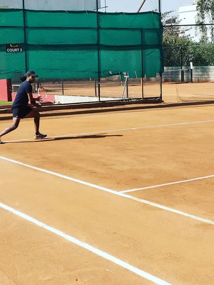 A player in position for a backhand during a match at the Tennis360 Academy UTR tour.