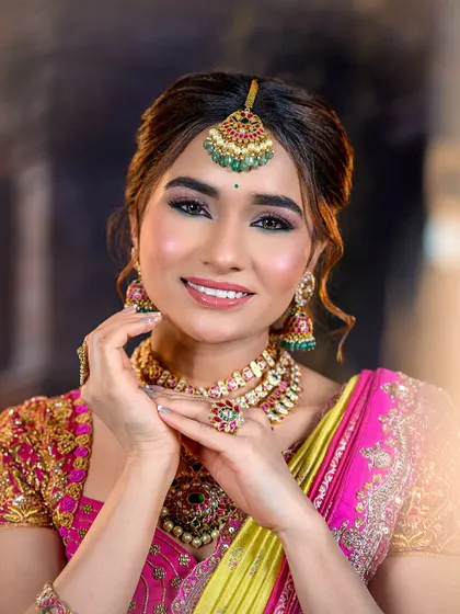 A close-up portrait of the model, focusing on her flawless skin and the beautiful details of her maang tikka and earrings.