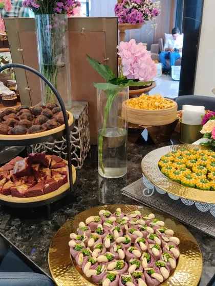 A colourful display of traditional Indian sweets and modern desserts at a housewarming party. We love to create spreads that blend different culinary styles to cater to diverse tastes.