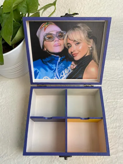 The inside of this music-themed organizer box is personalized with a photo. The compartments are perfect for storing jewelry, stationery, or other small treasures.