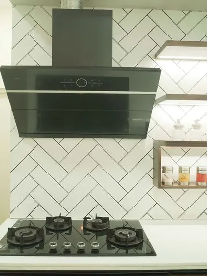 A beautiful L-shaped kitchen from a villa project, featuring dark wood cabinets and a white quartz countertop. The design includes open shelving and a stylish herringbone tile backsplash, creating a sophisticated and functional space.