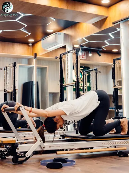 The "Long Stretch" on the Reformer is a full-body exercise that builds incredible core and upper body strength. This client demonstrates excellent form and control.
