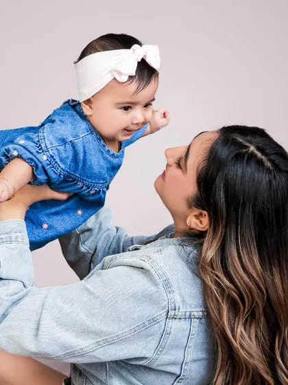 The bond between a mother and her child is a story without words. I aim to capture that pure connection in a simple, timeless portrait.