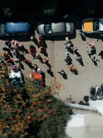 An aerial view of the baraat procession, showing the crowd of friends and family celebrating. This shot captures the grand scale of the event.