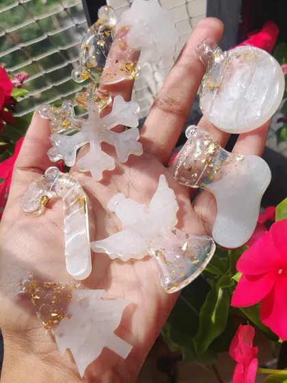 Add some sparkle to your tree with these resin Christmas ornaments. I make them in various shapes like snowflakes, angels, and candy canes, filled with glitter and color.