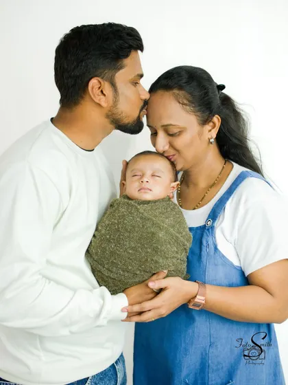 Kisses from both mom and dad. This photo is filled with warmth and affection, a beautiful memory of the love surrounding your baby from day one.