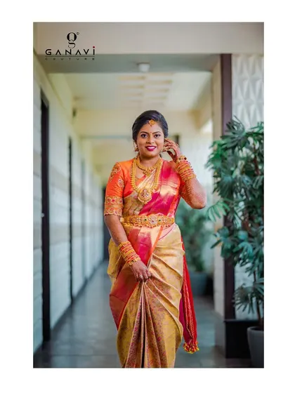 Yamuna walking with grace and confidence in her custom bridal ensemble. The combination of colors and the intricate handwork on her blouse make her a vision of beauty.