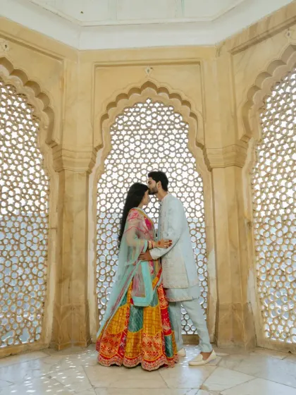 Inside the historic walls of Amber Fort, I use the intricate jali windows to frame your connection. It’s about finding those quiet, intimate moments amidst the royal splendor, creating a timeless portrait of your love.