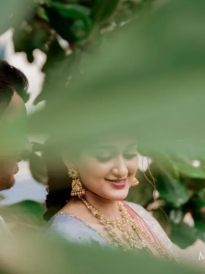 A soft, romantic shot of a couple during a pre-wedding event. The bride's makeup is natural and enhances her beautiful features.