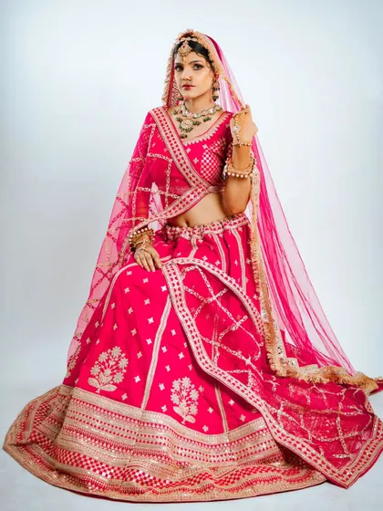This seated portrait shows the full grandeur of the lehenga skirt, making it a perfect shot for your wedding album.