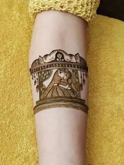 This beautiful armband features a traditional doli (palanquin) scene, symbolizing the bride's journey to her new home. It's a classic and emotional element for bridal mehndi.