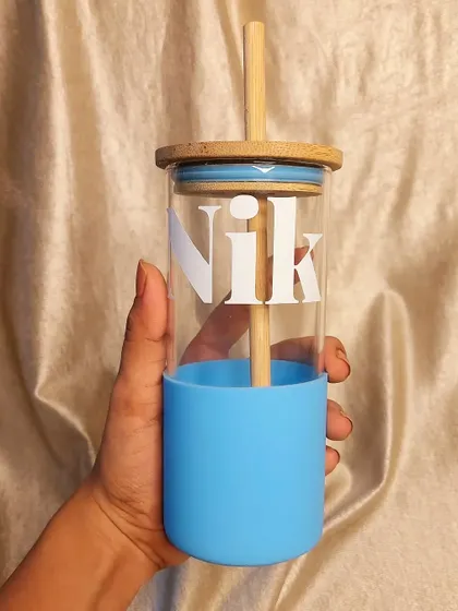 Stay hydrated with your perfect sipper companion. This glass tumbler with a bamboo lid and straw comes with a silicone sleeve and can be personalized with a bold initial design.