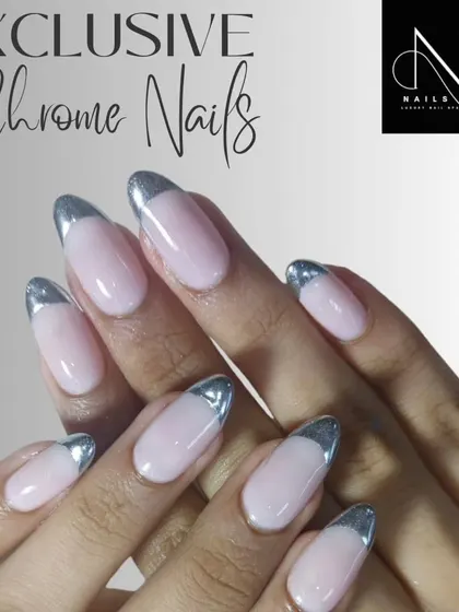 An elegant chrome French manicure. We used a highly reflective silver chrome for the tips on these almond-shaped nails, offering a modern alternative to the classic white.