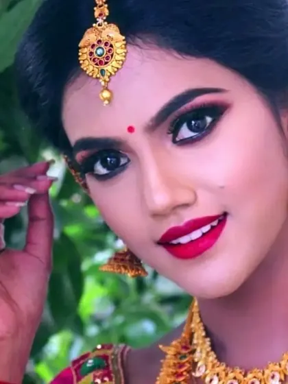 A close-up of a classic South Indian photoshoot look. I focused on creating sharp, defined eyes with a winged liner and a bright red lip, which beautifully complements the traditional gold jewelry.
