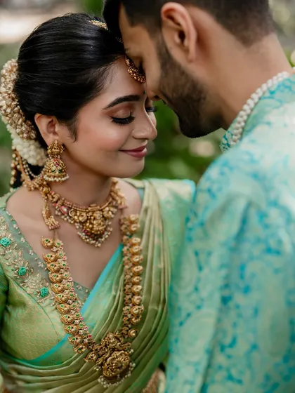 A tender moment between the couple, showcasing their beautiful coordinated outfits. Our goal is to capture the subtle emotions and details that make your wedding portraits special.