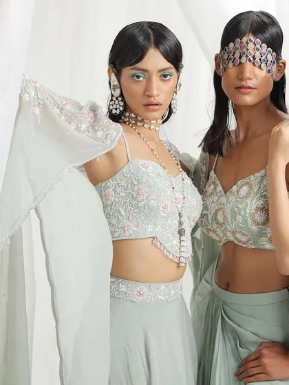 A trio of models in pastel green ensembles, showcasing different styles of blouses and drapes. This demonstrates my ability to offer variety within a single color palette for bridesmaids.