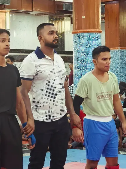 Happy moments with the team after a win. Here I am as the referee, raising the hands of the fighters.