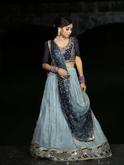 A full view of the sky-blue lehenga with a dark blue embroidered dupatta. The color combination is unique and elegant.