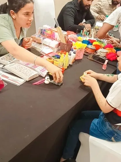 An art and craft station keeps the little ones creatively engaged. Here, a child is getting help with a craft project, one of the many activities I can arrange.