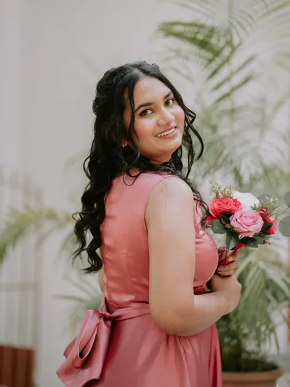 A bridesmaid looking elegant and happy. The makeup is soft and pretty, perfect for a wedding.