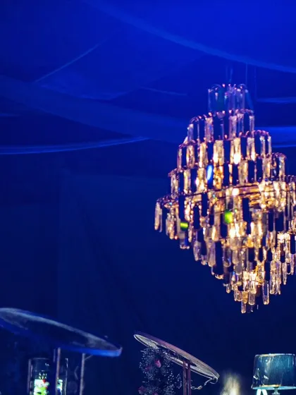 A crystal chandelier and a disco ball hang side-by-side, perfectly capturing the blend of elegance and party spirit.