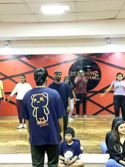 An instructor guiding students through a routine during showcase rehearsals. We ensure every dancer gets the attention they need to feel confident on stage.