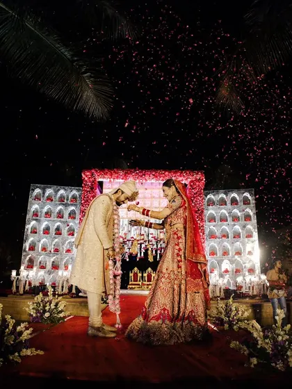 The fun and games of the varmala ceremony. This playful moment where the bride garlands the groom is a highlight of every wedding, and the decor is designed to make it a grand spectacle.