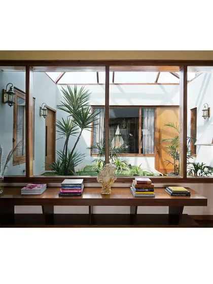A closer look at the lounge's view into the sunlit courtyard. The extensive use of glass and open sightlines ensures that even the home's innermost spaces feel bright, airy, and connected to the natural world.