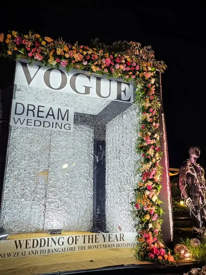 A custom-designed "Vogue Dream Wedding" photo booth, featuring a tunnel of shimmering crystals for a high-fashion, editorial feel.