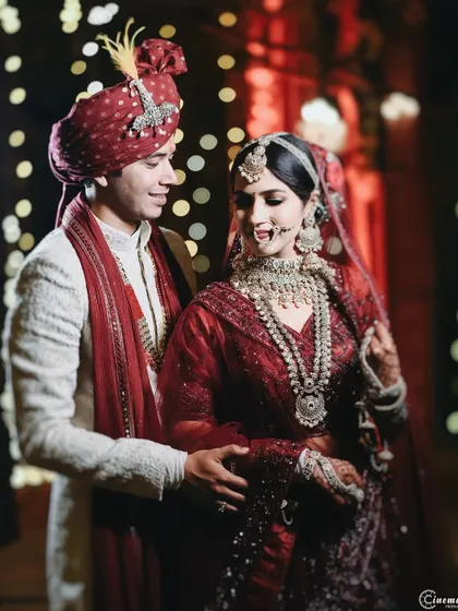 A classic portrait of the wedding couple. The groom's arm around his bride, their playful expressions, and the beautiful bokeh background make this a perfect shot.