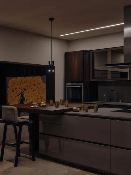 Another angle of the kitchen, showing the integration of the oven and the warm glow of a painting in the background. The design is both highly functional and aesthetically pleasing.