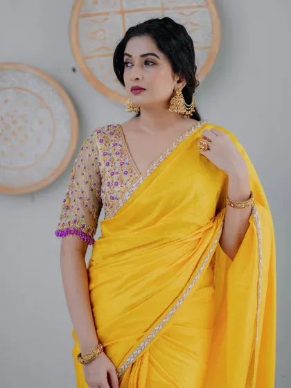 A portrait shot of actress Sonal Monteiro in the yellow hand-embroidered silk saree, a masterpiece of ethnic couture.