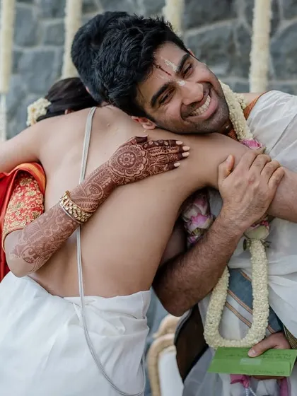 A playful moment during a Tamil wedding ritual. The joy and laughter shared between the couple are what make these candid shots so special and memorable.