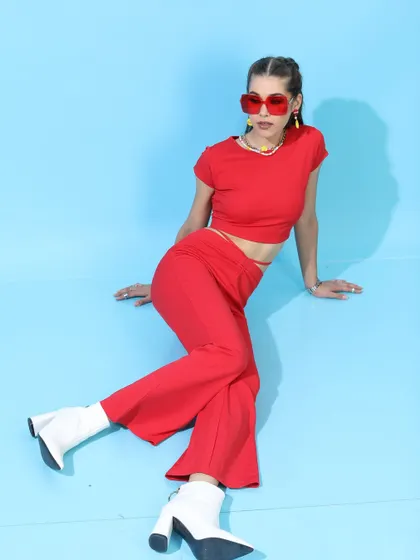 For this Tokyo Talkies shoot, I created a bold, monochromatic red co-ord set look. The flared pants and crop top are paired with contrasting white boots to make a powerful style statement.