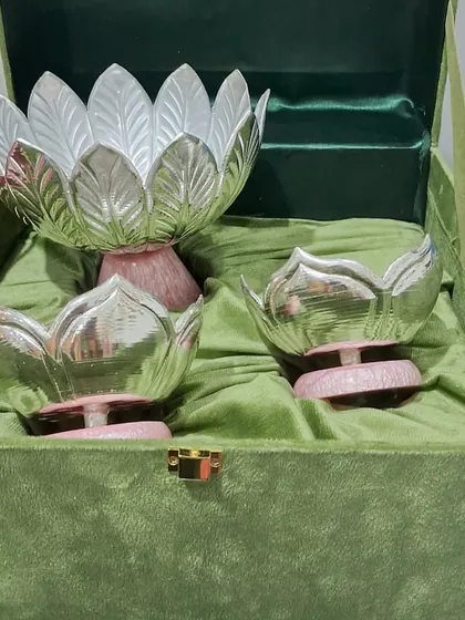 This is one of my favorite creations, a set of three lotus-shaped German silver bowls presented in a luxurious velvet box. The dual-tone finish and delicate craftsmanship make this a perfect heirloom gift for weddings, housewarmings, or any special milestone.