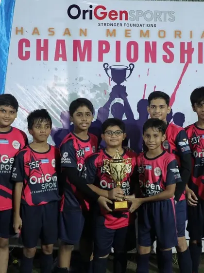 Our U13 boys' team proudly holding their trophy at the Hasan Memorial Championship. Competing and winning at this age is a huge confidence booster.